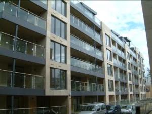 Stainless steel and glass corner balconies and railings, flashing, cladding and soffit.