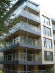 Stainless steel and glass corner balconies and railings, flashing, cladding and soffit.