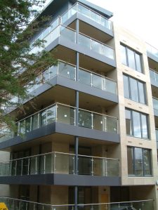 Stainless steel and glass corner balconies and railings, flashing, cladding and soffit.