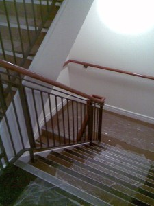 Internal stairs with banister and screw-to-wall handrail.