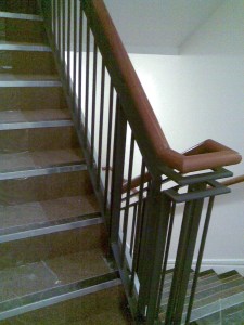 Internal stairs with banister and screw-to-wall handrail.